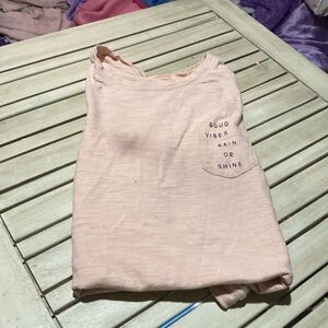 It’s an old navy shirt with a pocket with print that says good vibes